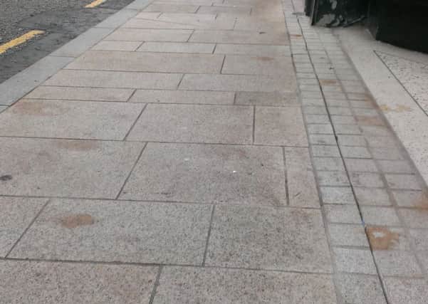 Stains on the recently-laid footpath on Larne Main Street. INLT-39-708-con