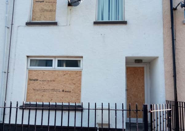 The boarded up Fleet Street home which was damaged by men wielding hatchets on Wednesday September 21. INLT-39-702-con