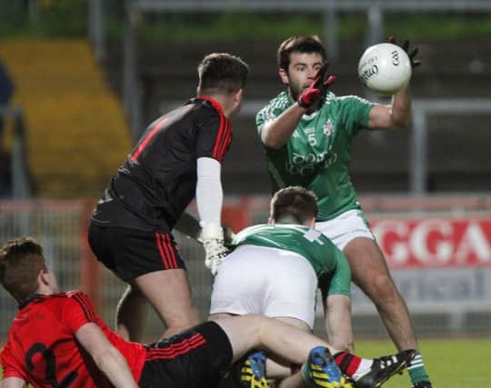 Ciaran McGervin gets a hold of the ball to score a goal for Derrylaughlan in the Intermediate Championship Final.