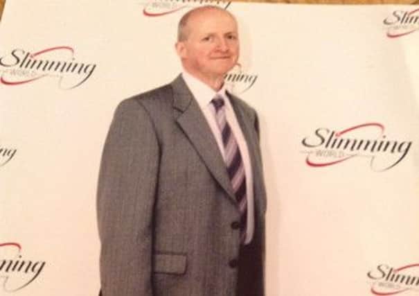 Michael Woods is celebrating after losing 16 stone at his local Slimming World group.
