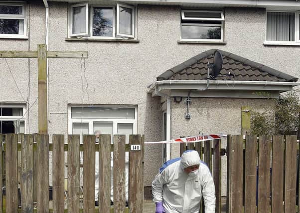 A forensic officer leaving the scene of the house in Lurgan