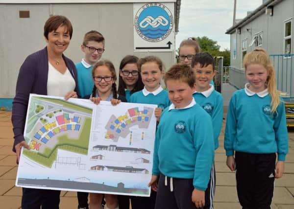 The principal of Corran Integrated Primary School, Mrs Denise Macfarlane and pupils from P4,5 & 6 with plans for their new school. INLT 26-001-PSB