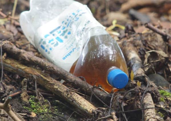 One of the bottles of urine which has been dumped along the Inver River Path. INLT-40-710-con