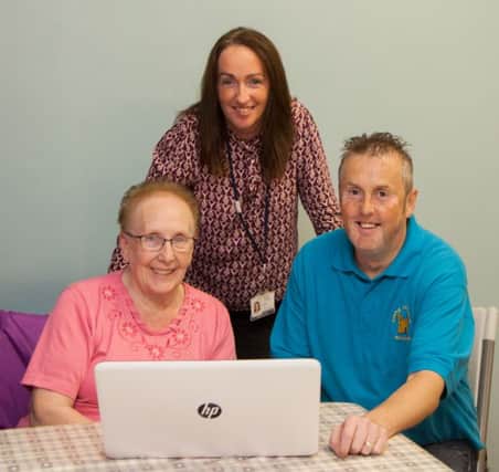 Enjoying the weekly computer class are local residents, Emma Quigg (left) and Martin Neill (right) with Housing Executive Housing Officer Noeleen Connolly (centre).