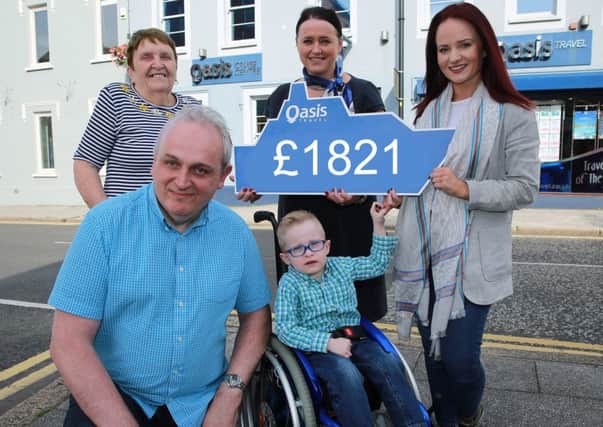 Ian Green and his mum, Joan, (back left), are pictured collecting their cruise tickets from Briege McElroy, Manager of Oasis Travel Lisburn, as Cavan ONeill and his mum, Emma, look forward to the journey which they hope will change Cavans life. Pic by Bill Smyth