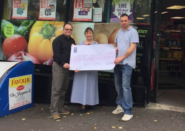 Jeffrey and Adeline Williamson, owners of the Hillhall Costcutter store, and Francie Ferris (right), Resurgam Trust Area Youth Worker.
