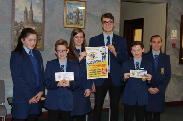 The fundraising Loreto Superdraw is launched by the Colleges Head Girl and Head Boy, Cariosa OHarte and Aidan Boyle, along with a group of Year 8 students.