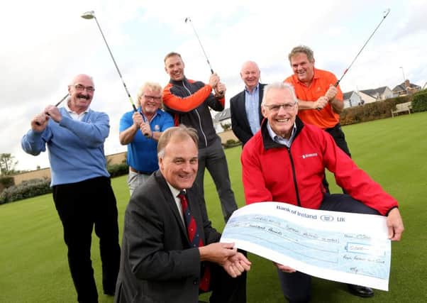 Michael Taylor, captain of Royal Portrush Golf Club, presents a cheque for Â£10,000 to Ian Crowe, Chairman of the Air Ambulance NI as Liam Beckett, Albert Kirk, Stephen Ferris, Mervyn Whyte and Adrian Logan look on.