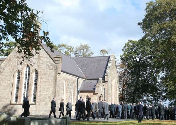 Mourners gather outside St Johns Church near Hillsborough before the funeral of Drew Nelson