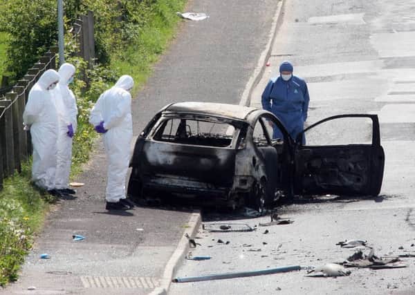 13/05/08: Forensic officers at the scene of a booby-trap car bomb attack on an off-duty Catholic policeman