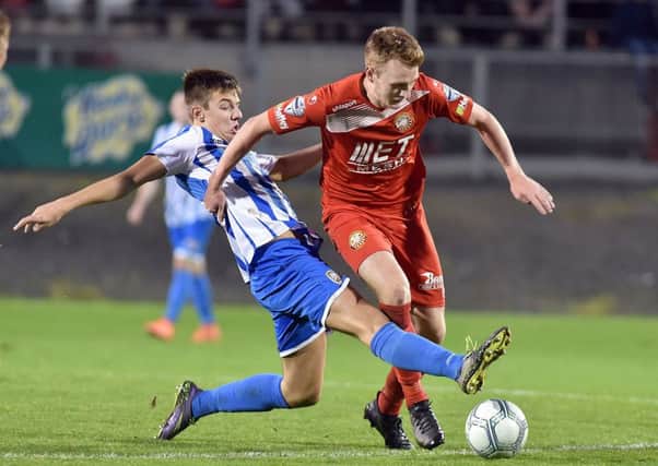 Brad Lyons sliding in to stop Portadown's Aaron Haire on Saturday evening, Pic by PressEye Ltd.