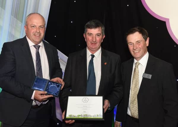 Chairman of Hillsborough in Bloom, James Baird with Councillor James Tinsley accept one of the awards Hillsborough picked up at the Britain in Bloom 2016 ceremony. 
The village has been awarded a Gold Award in the Large Village category and the Heritage Award. Also pictured is Roger Burnett is chairman of the Britain in Bloom judging panel.