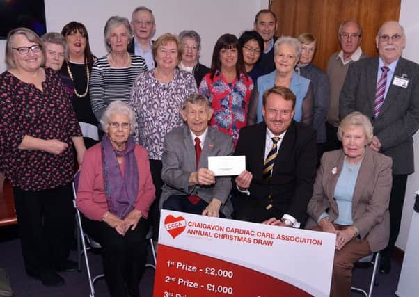 Pictured at the launch of the Craigavon Cardiac Care Association annual draw are committe members and president, George Johnston, front row second from left, who sold the first ticket to Councillor Colin McCusker ws a representative of ABC Council. INPT43-200.