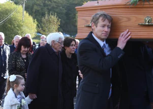 Former Deputy First Minister Seamus Mallon and his daughter Orla lead the cortege after his wifes funeral in Markethill