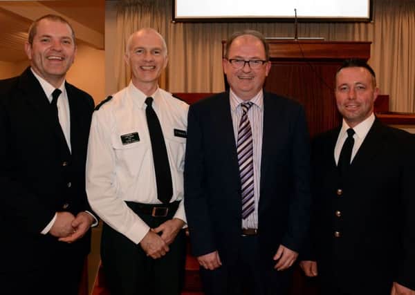 Pastor Ian Wilson welcomes firefighter Samuel Heenan and firefighter Derek Bell of the Northern Ireland Fire and Rescue Service along with PSNI Inspector Leslie Badger to the official reopening of Rathfriland Baptist Church. Photo by Gary Gardiner.  INBL WK 4616-509