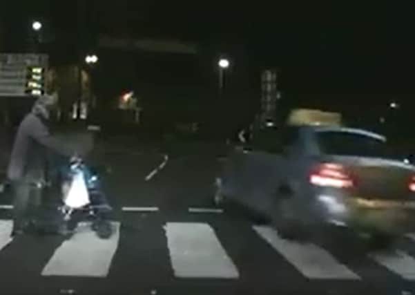 The moment a taxi driver almost collides with a pedestrian at a zebra crossing in Londonderry