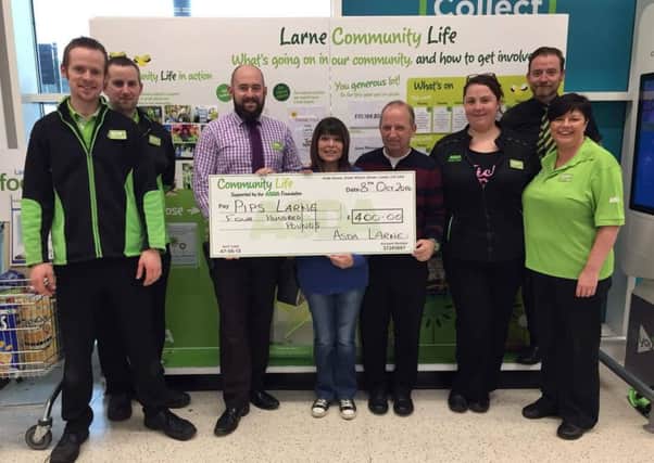 PIPS Larne Chair Carlee Letson is pictured with staff from ASDA who donated a cheque for Â£400 to the suicide prevention charity. INLT-43-708-con