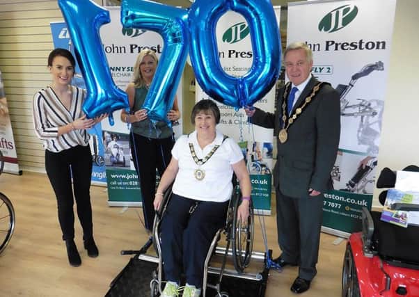 Mayor Brian Bloomfield and Mayoress Rosalind Bloomfield help John Preston Healthcare Group employees Clare Grant (Marketing Executive) and Ann Ferguson (Product Specialist and Customer Services) get rolling on their 170-mile wheelchair challenge.