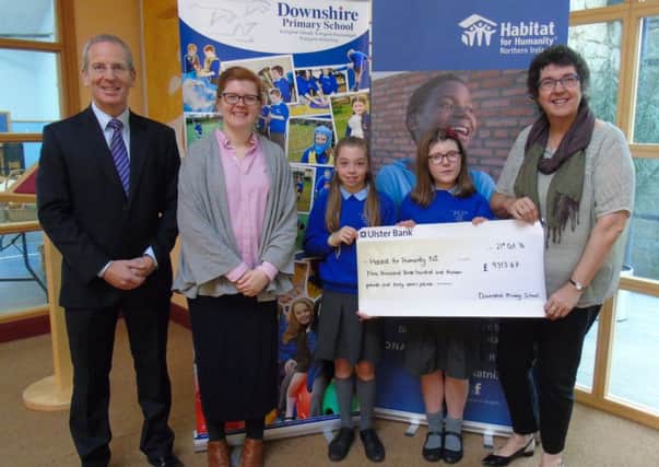 Presenting the cheque are (L_R) John Knaggs (Principal), Sarah McKinney (teacher) and Primary 7 pupils to Jenny Williams, Chief Executive of Habitat for Humanity Northern Ireland.