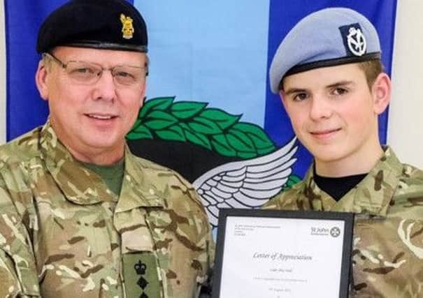 Colonel David Kane presents a First Aid Commendation certificate to  Cadet Lance Corporal Alex Todd, who saved his Dad from choking. INLT-46-701-con