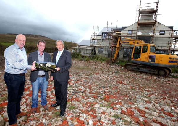 Checking out the new Â£1.75 million Standing Stones tourist accommodation and restaurant development are: (l-r) Alderman James Tinsley; Paul McLarnon, owner of the development, and Councillor Uel Mackin, Chairman of the Council's Development Committee.