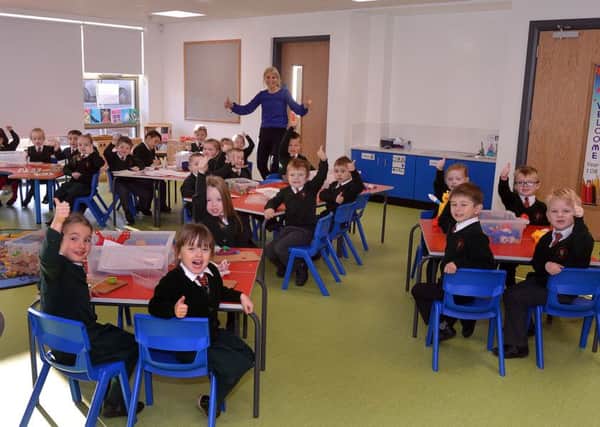 Its a big thumbs up from Millington Primary School P1 pupils as they give their verdict on their new classroom in the school's 12 room extension which was opened on Monday. also included is P1 teacher Mrs Wendy Ogilby-Black. INPT45-200.