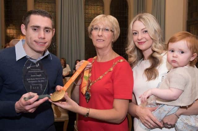 The Mayor Alderman Hilary McClintock pictured with five times Paralympic 100m Champion Jason Smyth during a reception at the Guildhall to mark his latest gold medal at the Rio Games. Included are Jason's wife Elise and daughter Evie. Pictures: Martin McKeown. Inpresspics.com. INLS 46-708-CON