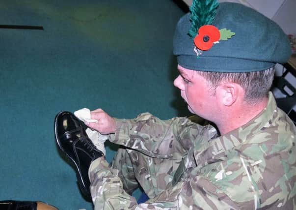 Rgr Neill Young Bulling shoes in preparations for Remembrance Sunday.