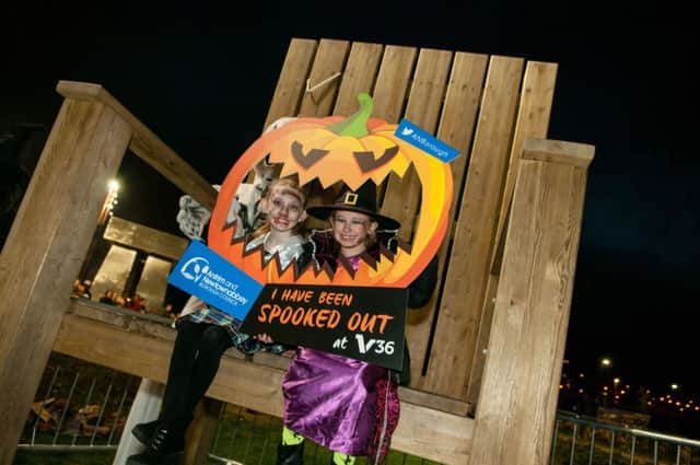 Charlie Moseley and Olivia Moore enjoying the Giant's Chair at the Spooked Out at V36 event