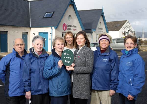 Samantha Corr, Tourism NI presents the Glenarm Visitor Information Point Activity Tours staff with the four star grading award (Picture by Darren Kidd / Press Eye).