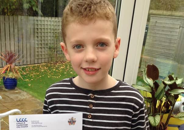Ross Campbell (9) with his letter from Lisburn and Castlereagh City Council.