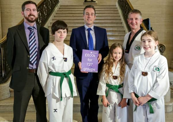 Pictured with Minister Paul Givan are members of martial arts club Cheol Taekwondo Academy which received a Â£960 grant and Johnny McShane from LCDI who deliver the  Volunteering Small Grants Programme on behalf of the Department for Communities. Pic by Brian Thompson