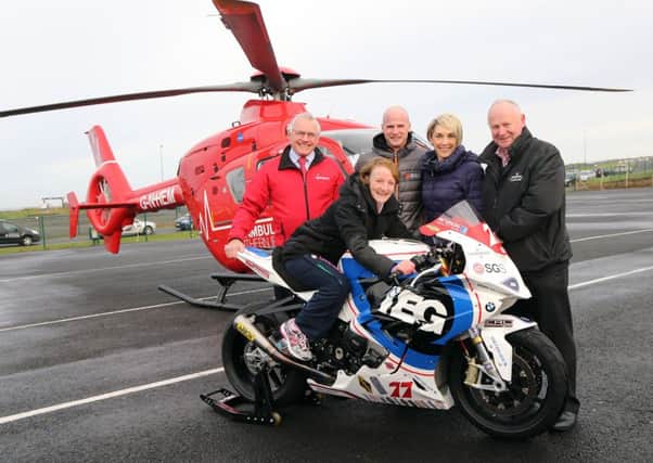 Violet McAfee, the spectator injured in a crash at the 2015 North West 200, with Ian Crowe, Chairman of the NI Air Ambulance,  Ryan Farquhar and his wife, Karen and NW200 Event Director, Mervyn Whyte.