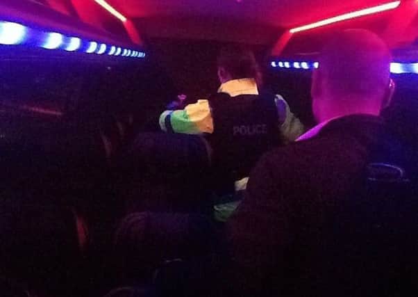 PSNI officers search a bus as it arrives at a teenage disco in Cookstown.