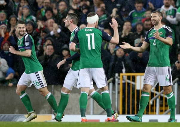 Northern Ireland's Gareth McAuley (right) celebrates with his team mates after scoring his side's second goal.