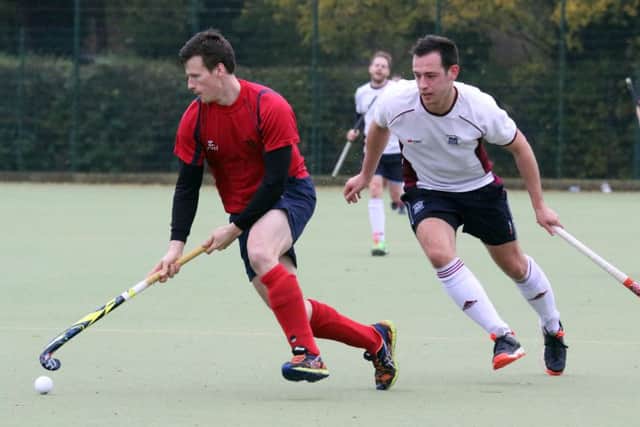 Banbury's Harry Loxton comes away from Milton Keynes' Myles Locke with the ball