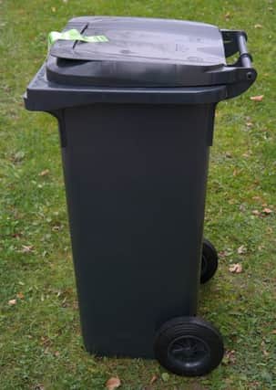 A black rubbish bin. INLT-47-716-con