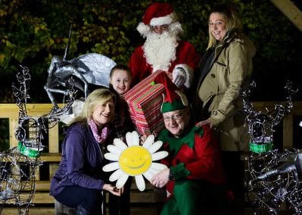 Angela Mullholland (Cancer Fund for Children) with Castle Garden visitors Aimee and Charlene Rodgers and Santa with his elf.