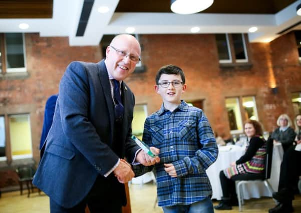 Peter Eakin Chair of NI Council MS Society presents Glenn with hi swell deserved award. (Submitted image)