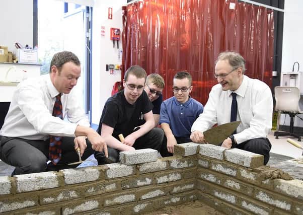 The Minister is pictured with Principal of Jordanstown School, Adam Smith and pupils Cathal Brolly, Karl Lipton and Dylan Curran. Picture by Michael Cooper. INNT 47-824CON