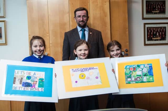 Winner of the Community Planning Poster Competition Eleanor Fyfe from St Patrick's Primary School in Glenariff (centre) pictured with Robyn Baird from Rasharkin Primary School who came second and Amelie Holden who came third along with Councillor George Duddy, Chairman of the Community Planning Strategic Partnership.
