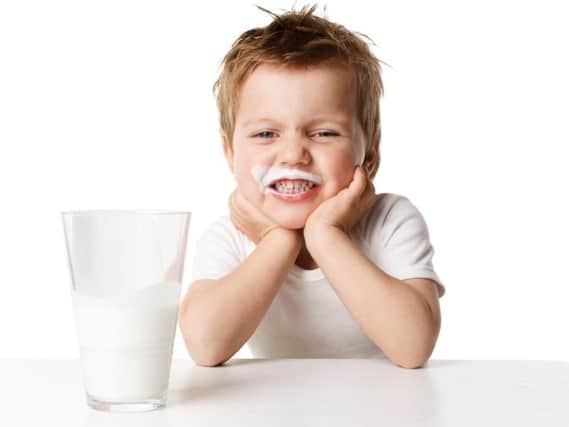 A youngster enjoying his milk