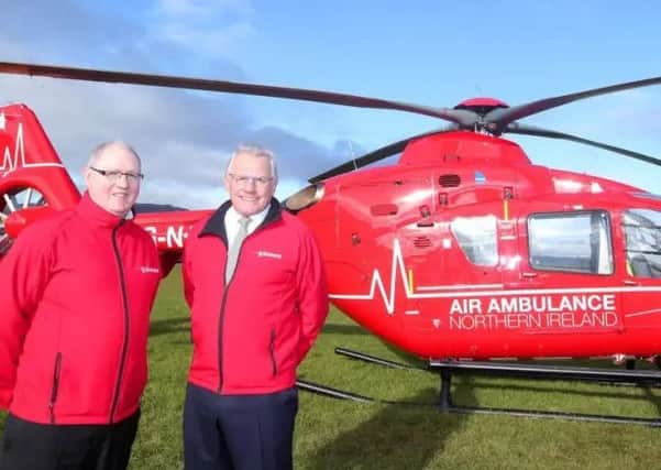 Air Ambulance Northern Ireland trustee Ray Foran (left) and chairman Ian Crowe with one of the two helicopters which will deliver Northern Ireland's first-ever Helicopter Emergency Medical Service.