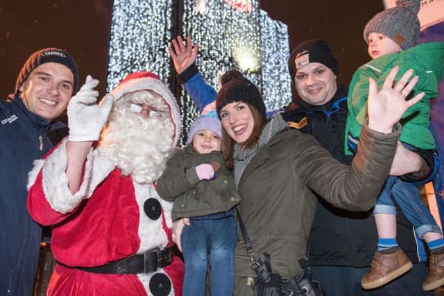 Santa pictured with Shane, Connie and Megan McGrinder and Davy, Sam and Alison Graham after he switched the Christmas lights. Picture Martin McKeown. Inpresspics.com. INLS 48-702-CON