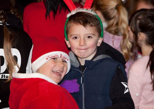 Two children seem to be having fun at the Christmas lights switch on in Portadown