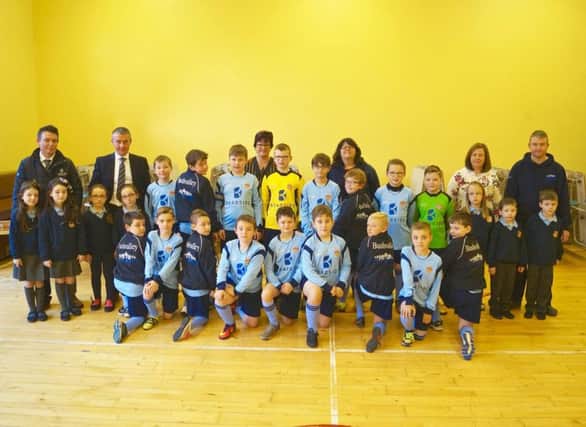 Both Bushvalley football teams showing off the new kits.  Picture includes Mrs P.  Whyte (Principal), Mrs L.  Creelman (Teacher and After School Games Co-ordinator).  Photographed also are Ian and Mark Lamont from Roadside Garages and their children Summer, Jazmin, Izzy and Ellis and Philip and Charlaine from PS Engineering with their children Sophie, Jordan and Tommy.