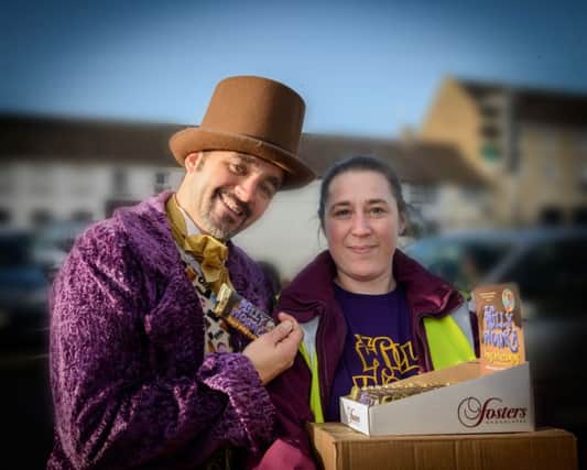 Niall Heron as Willy Wonka and Kerry Corr, Stewartstown Amateur Dramatic Society Committee Member deliver the first box of Wonka Bars to Dalys in Stewartstown.