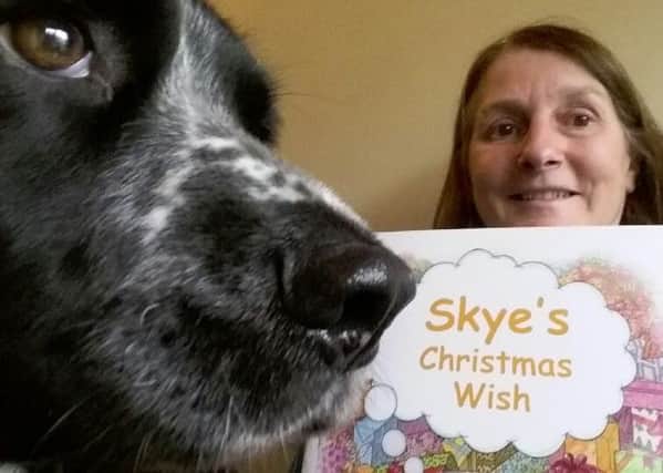 Hilary Bailey and Skye the dog with 'Skye's Christmas Wish.' INLT-49-704-con