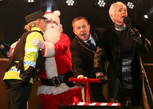 Santa gets a kiss from a local PSNI officer at the the switching on of the Christmas LIghts in Lurgan