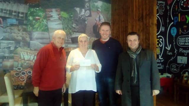 Angela Chambers receiving a cheque for Action Cancer from Alan McClarty (second right). Also pictured are cast members of 'Of Mice and Men' Harry Stinson (left) and Andy Shaw (right).